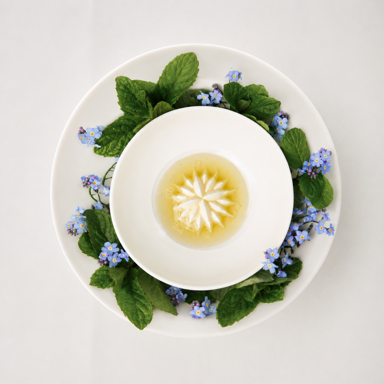 White chocolate and buttermilk dessert made with Saint Honore Blossom silicone mold by Nordic Chefs, served with elderflower sauce and edible flowers.