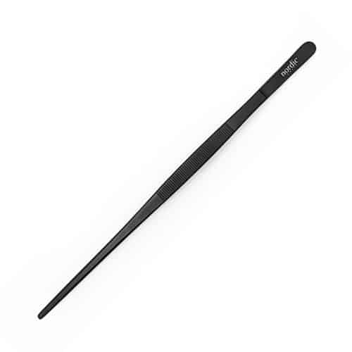Black metal cooking chopsticks on white background.