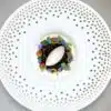 Elegant dessert with ice cream and colorful flowers.