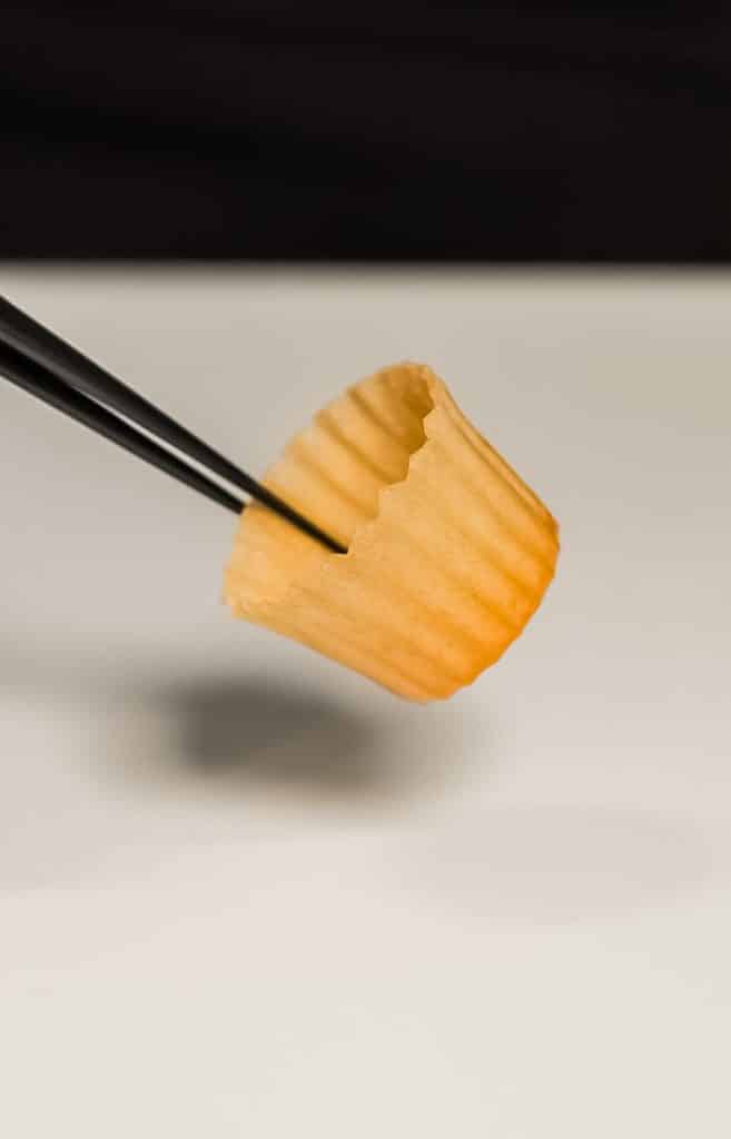 Cupcake liner held by chopsticks