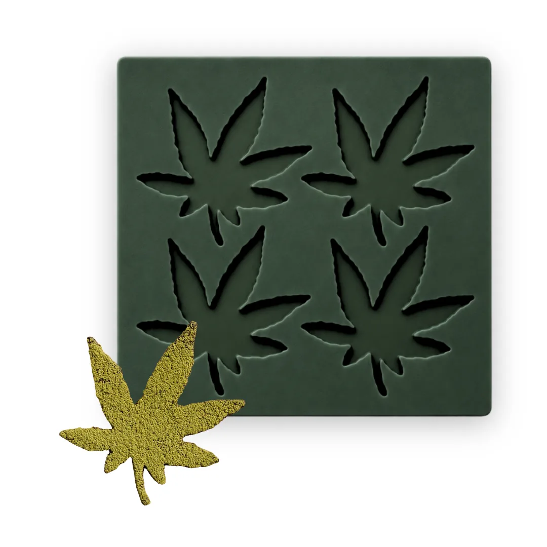 Cannabis leaf tuile mold with four silicone cavities and a finished leaf tuile